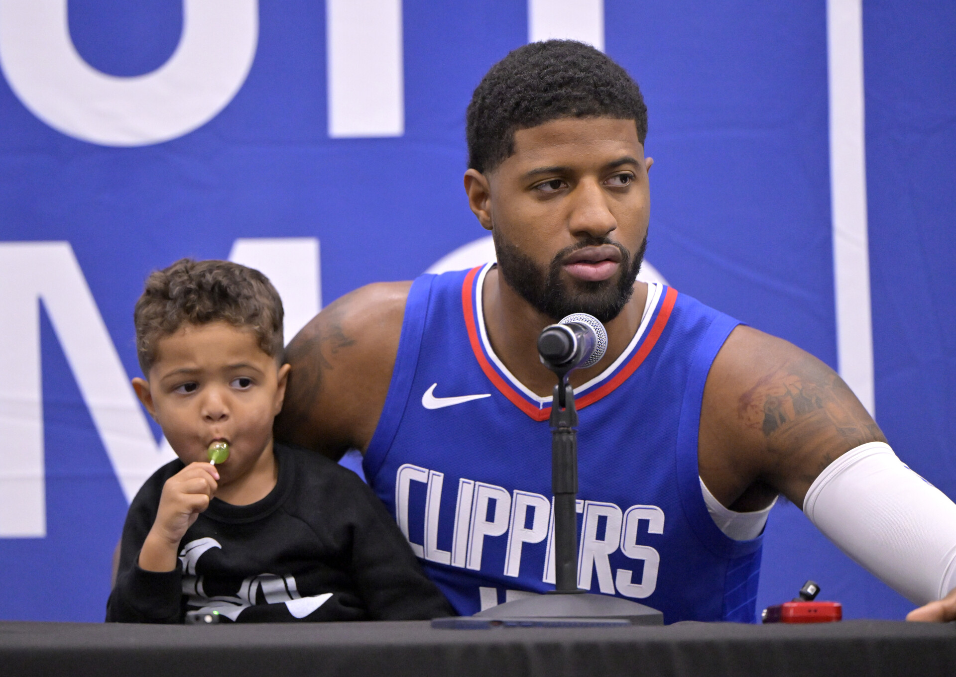 Oct 2, 2023; Los Angeles, CA, USA; Los Angeles Clippers forward Paul George (13) with his two year old son Paul Vuk George, during a new conference on media day at the Honey Training Center in Playa Vista, CA