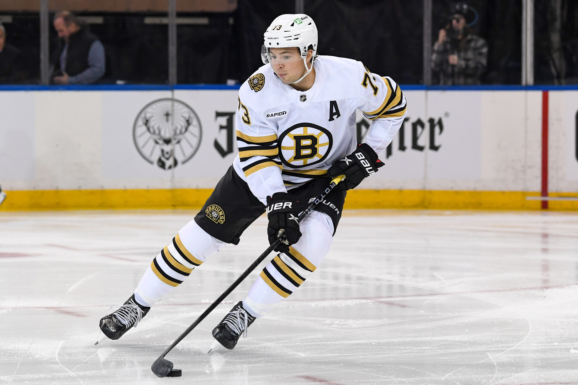 Oct 5, 2023; New York, New York, USA; Boston Bruins defenseman Charlie McAvoy (73) skates with the puck against the New York Rangers during the first period at Madison Square Garden.