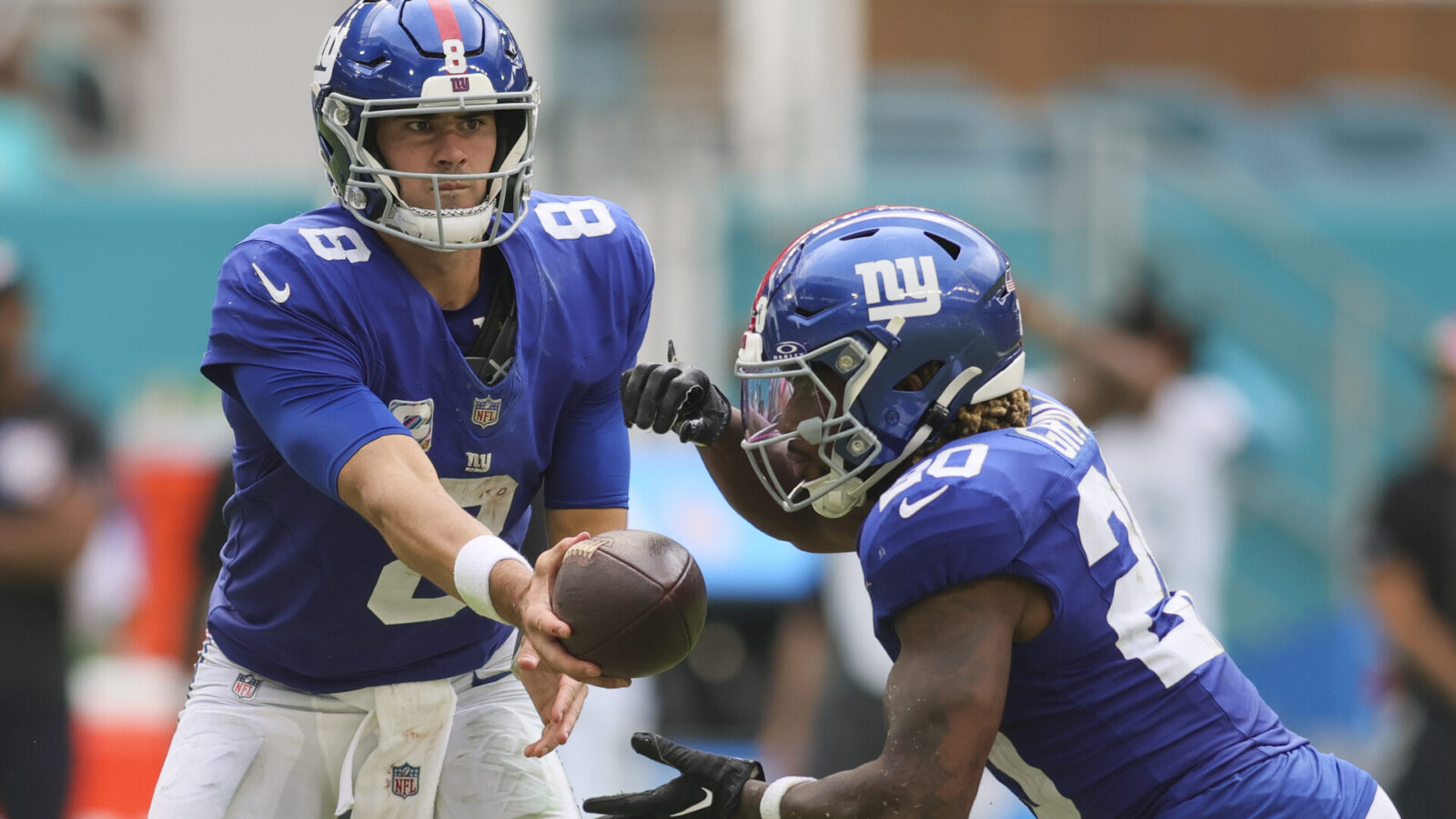 Oct 8, 2023; Miami Gardens, Florida, USA; New York Giants quarterback Daniel Jones (8) hands the football to running back Eric Gray (20) against the Miami Dolphins during the third quarter at Hard Rock Stadium.