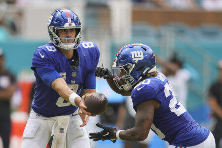 Oct 8, 2023; Miami Gardens, Florida, USA; New York Giants quarterback Daniel Jones (8) hands the football to running back Eric Gray (20) against the Miami Dolphins during the third quarter at Hard Rock Stadium.