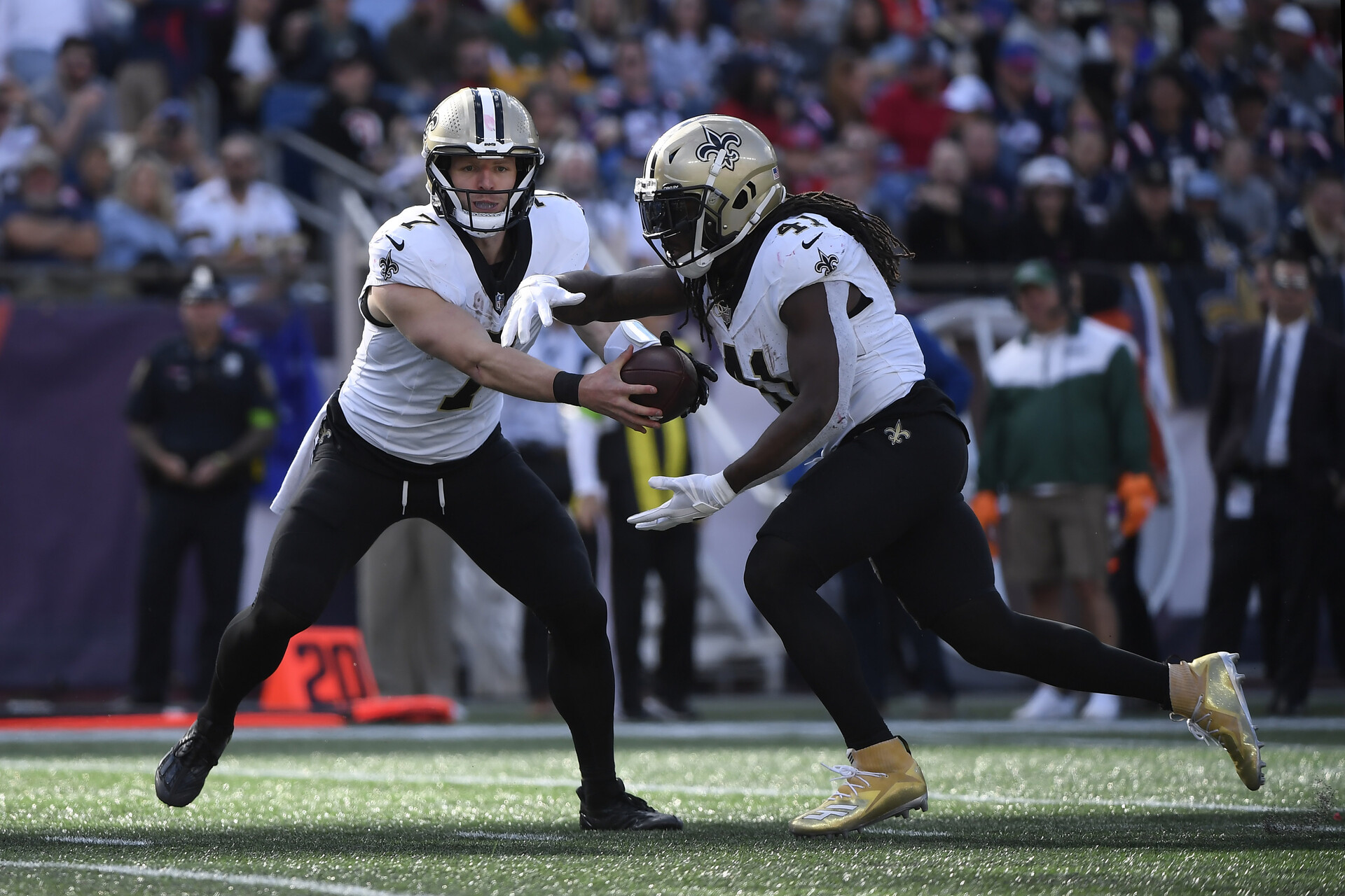 Oct 8, 2023; Foxborough, Massachusetts, USA; New Orleans Saints quarterback Taysom Hill (7) hands the ball off to running back Alvin Kamara (41) during the second half at Gillette Stadium.