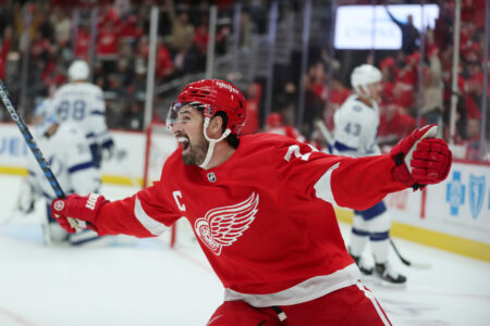 Detroit Red Wings center Dylan Larkin celebrates a goal by right wing Alex DeBrincat against Tampa Bay Lightning goaltender Jonas Johansson during first-period action on Saturday, Oct. 14, 2023, in Detroit, Michigan.