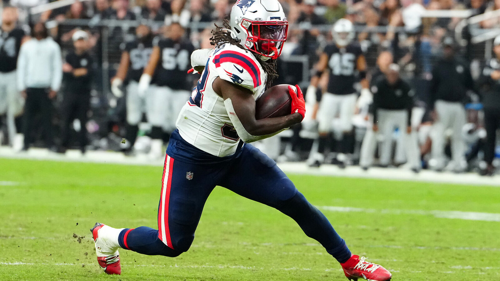 Oct 15, 2023; Paradise, Nevada, USA; New England Patriots running back Rhamondre Stevenson (38) rushes against the Las Vegas Raiders during the fourth quarter at Allegiant Stadium.