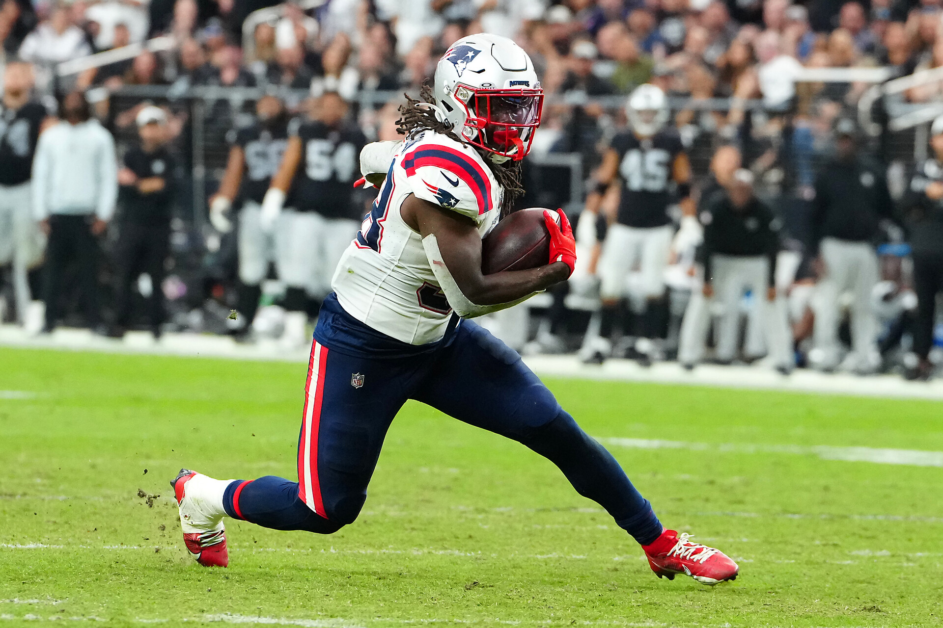 Oct 15, 2023; Paradise, Nevada, USA; New England Patriots running back Rhamondre Stevenson (38) rushes against the Las Vegas Raiders during the fourth quarter at Allegiant Stadium.