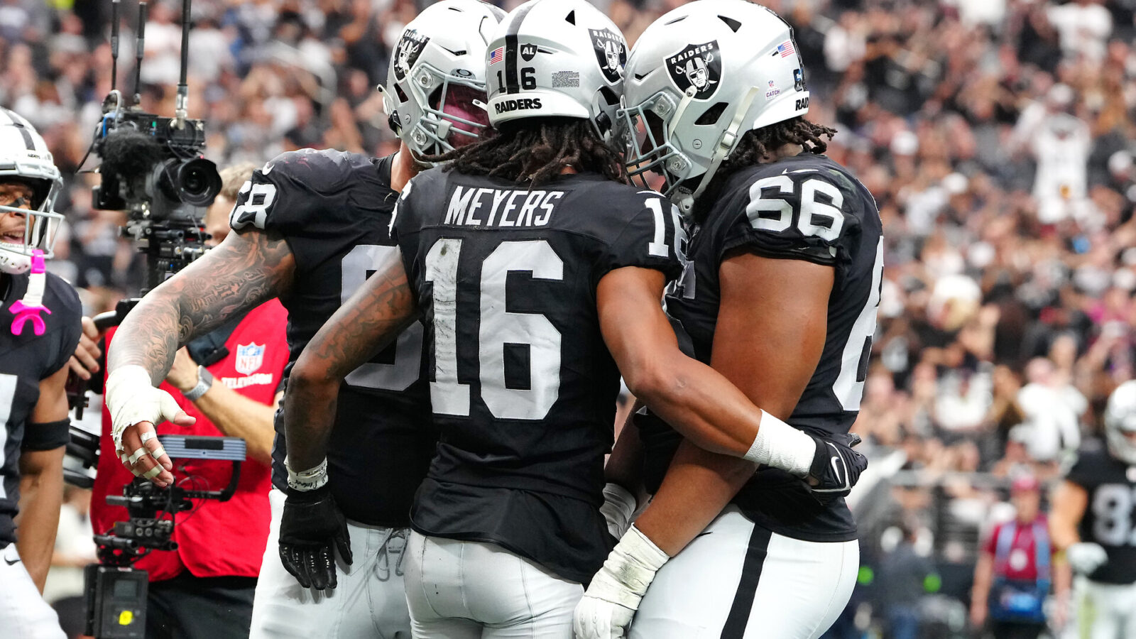 Oct 15, 2023; Paradise, Nevada, USA; Las Vegas Raiders wide receiver Jakobi Meyers (16) celebrates with team mates after scoring a touchdown against the New England Patriots during the second quarter at Allegiant Stadium.