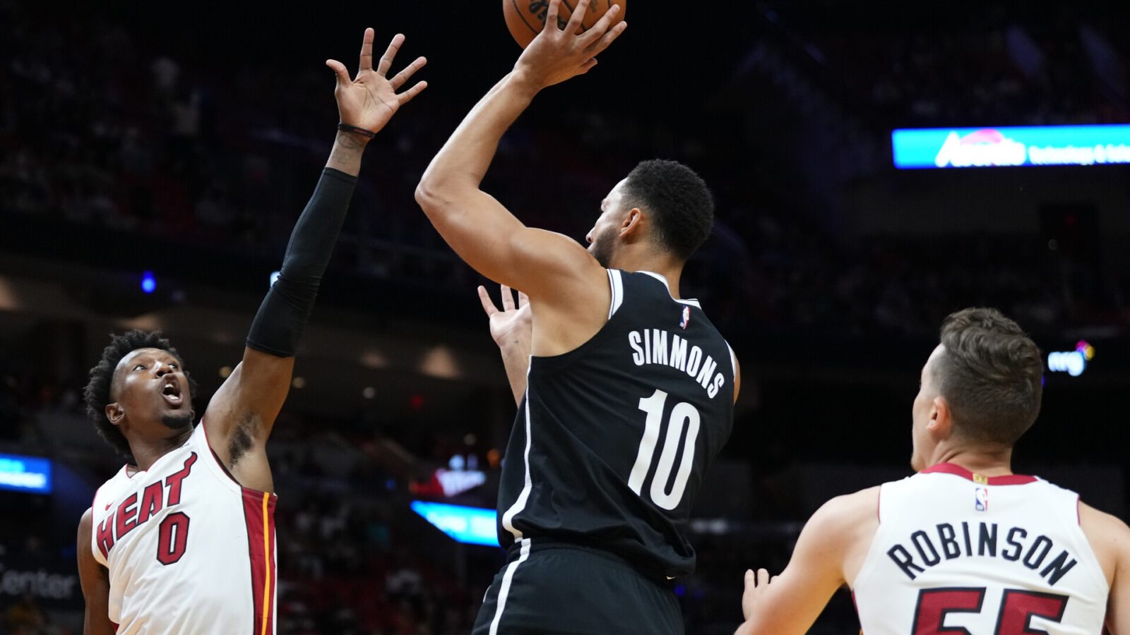 Oct 18, 2023; Miami, Florida, USA; Brooklyn Nets guard Ben Simmons (10) shoots over Miami Heat guard Josh Richardson (0) during the first quarter at Kaseya Center.