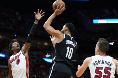 Oct 18, 2023; Miami, Florida, USA; Brooklyn Nets guard Ben Simmons (10) shoots over Miami Heat guard Josh Richardson (0) during the first quarter at Kaseya Center.