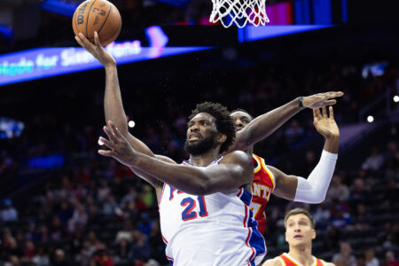 Oct 20, 2023; Philadelphia, Pennsylvania, USA; Philadelphia 76ers center Joel Embiid (21) drives for a shot past Atlanta Hawks forward Onyeka Okongwu (17) during the fourth quarter at Wells Fargo Center.