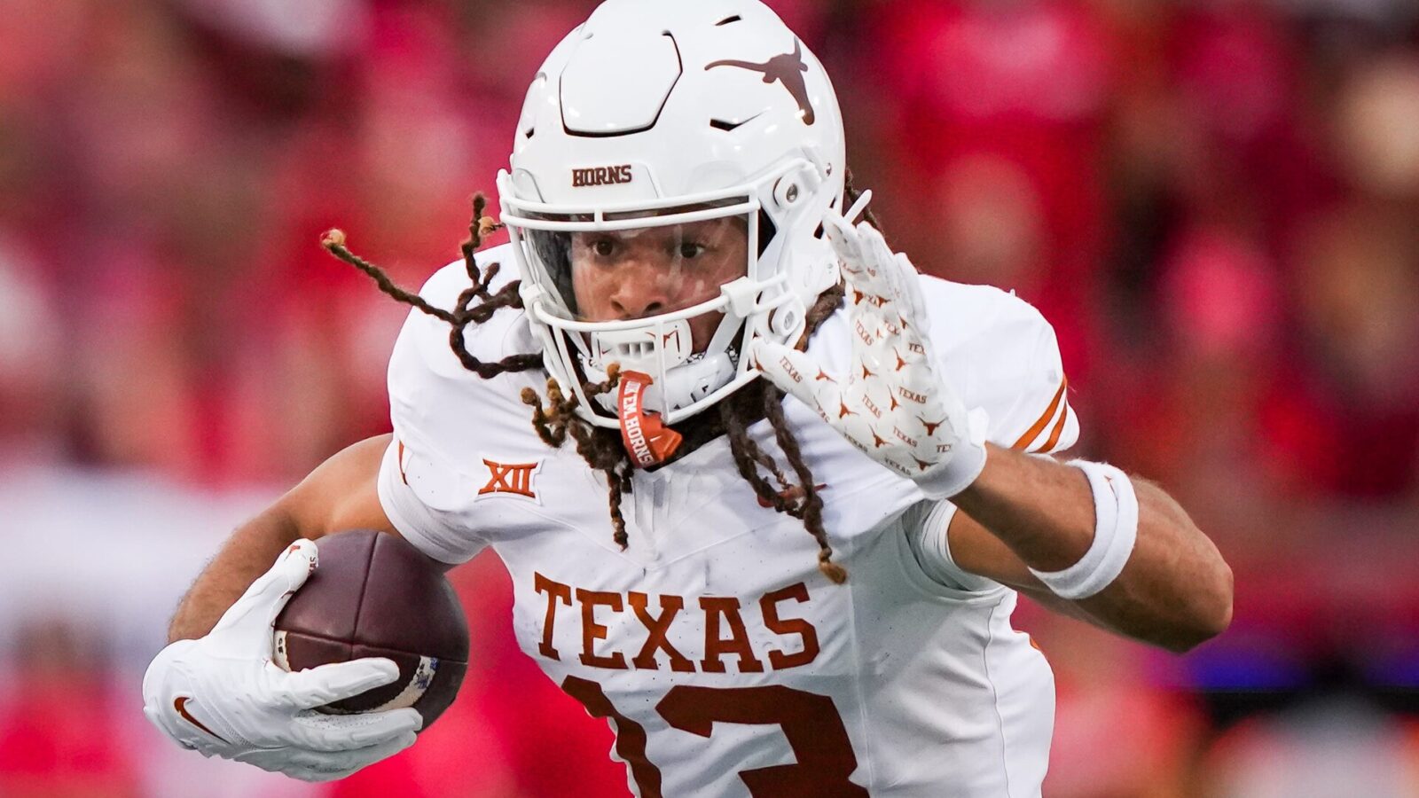 Texas wide receiver Jordan Whittington (13) runs with the ball in the fourth quarter of the Longhorn's game against the Houston Cougars at TDECU Stadium in Houston, Saturday, Oct. 21, 2023. Texas won the game 31-24.