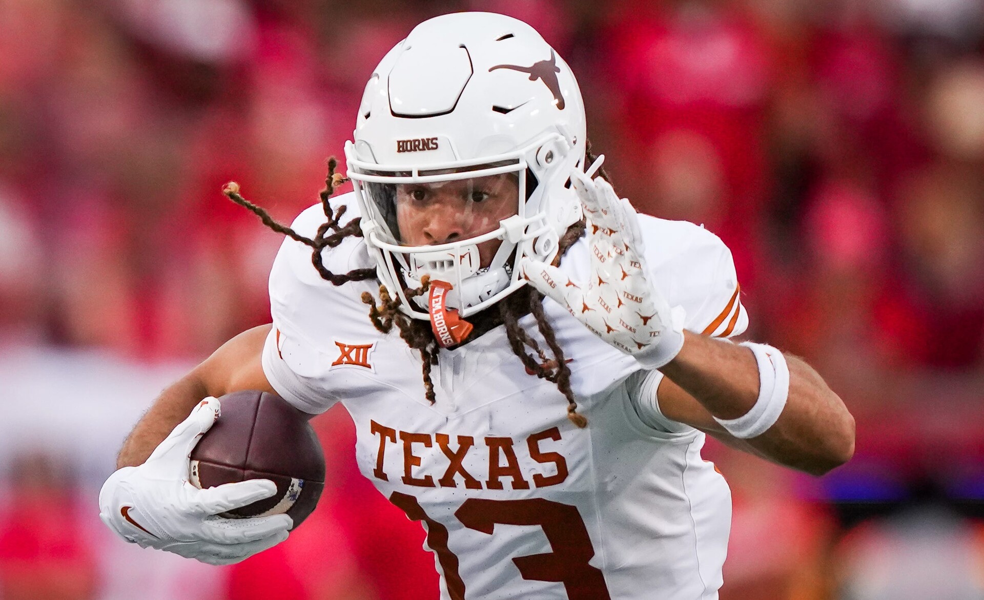 Texas wide receiver Jordan Whittington (13) runs with the ball in the fourth quarter of the Longhorn's game against the Houston Cougars at TDECU Stadium in Houston, Saturday, Oct. 21, 2023. Texas won the game 31-24.