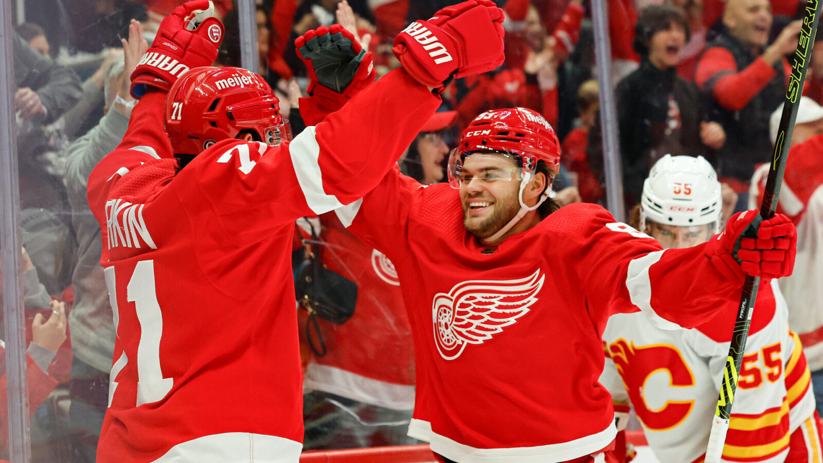 Detroit Red Wings center Dylan Larkin (71) celebrates with right wing Alex DeBrincat (93) after scoring in the second period against the Calgary Flames at Little Caesars Arena.
