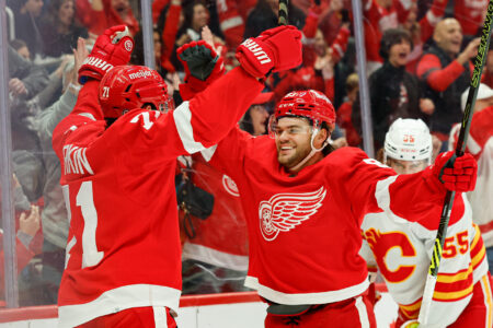 Detroit Red Wings center Dylan Larkin (71) celebrates with right wing Alex DeBrincat (93) after scoring in the second period against the Calgary Flames at Little Caesars Arena.