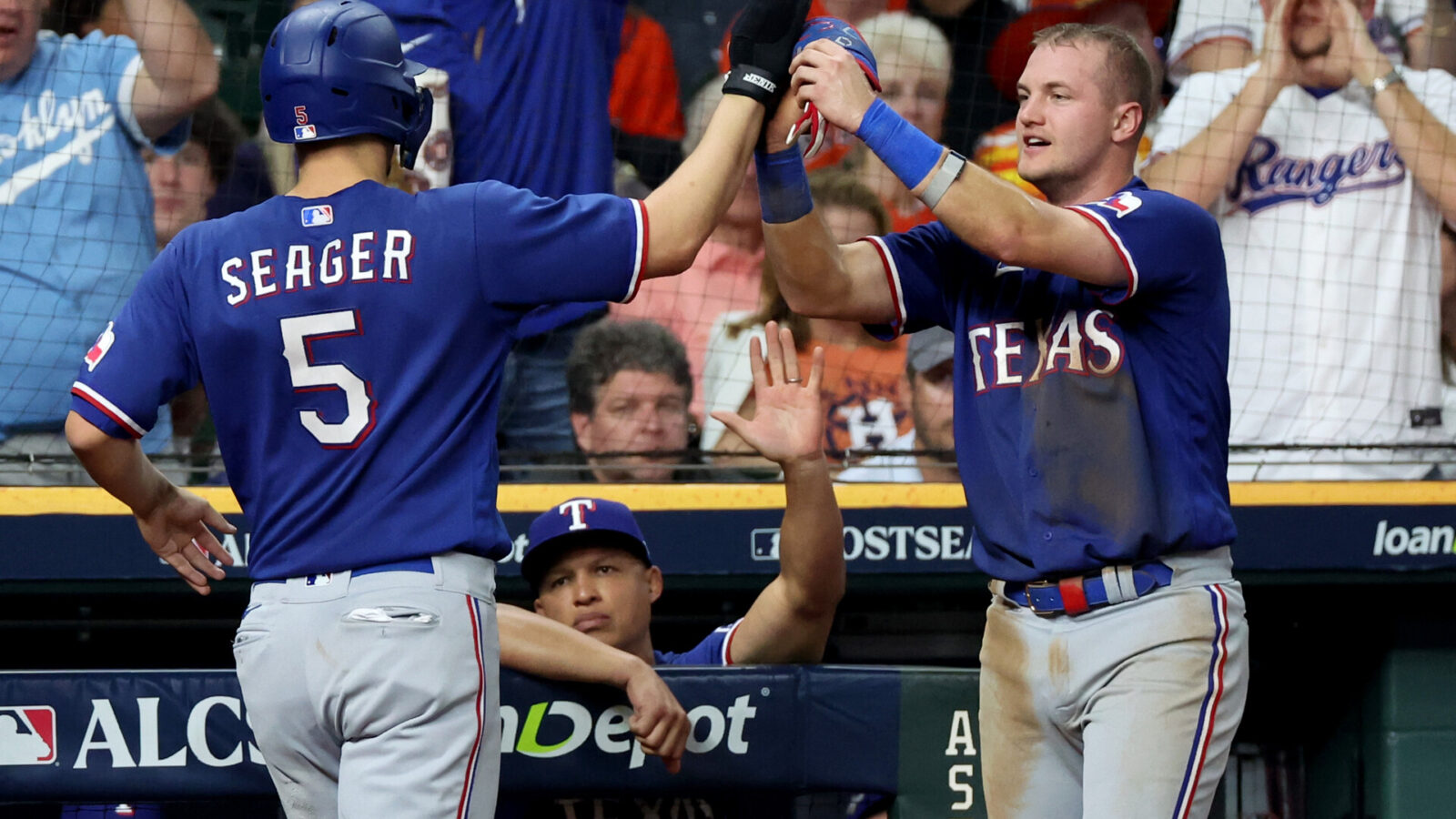 Oct 23, 2023; Houston, Texas, USA; Texas Rangers shortstop Corey Seager (5) and third baseman Josh Jung (6) celebrate after a run during the fourth inning of game seven in the ALCS against the Houston Astros for the 2023 MLB playoffs at Minute Maid Park.