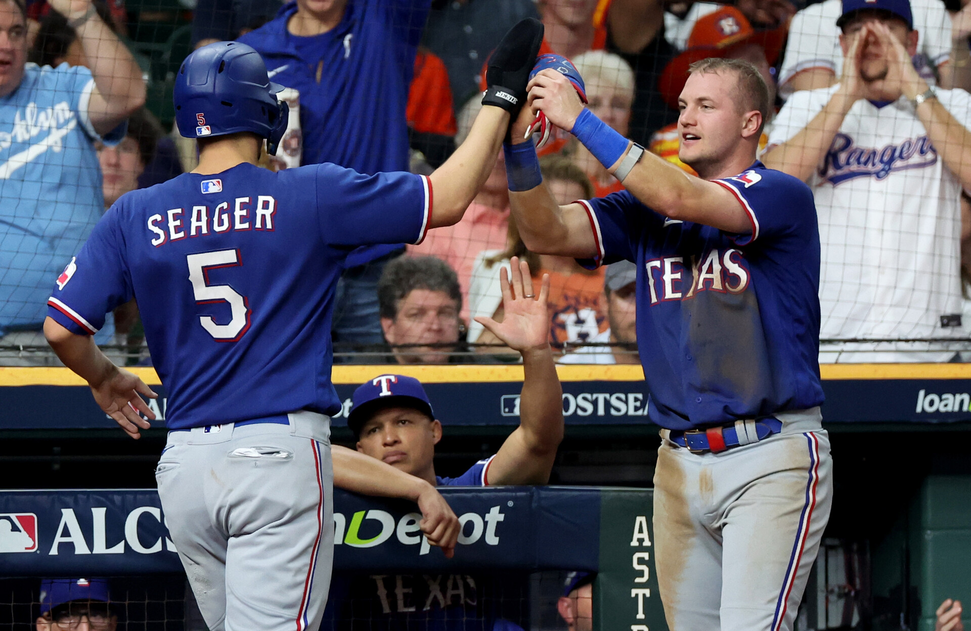 Oct 23, 2023; Houston, Texas, USA; Texas Rangers shortstop Corey Seager (5) and third baseman Josh Jung (6) celebrate after a run during the fourth inning of game seven in the ALCS against the Houston Astros for the 2023 MLB playoffs at Minute Maid Park.