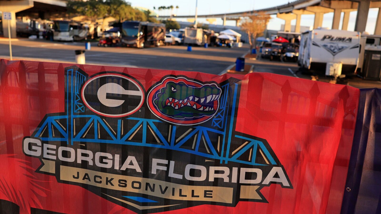 Signage hangs on a fence outside RV City Tuesday, Oct. 24, 2023 at parking lot E of EverBank Stadium in Jacksonville, Fla. Dozens of RVs and people came to tailgate for the days leading up to this Saturday, Oct. 28 for the annual Florida-Georgia college football game.