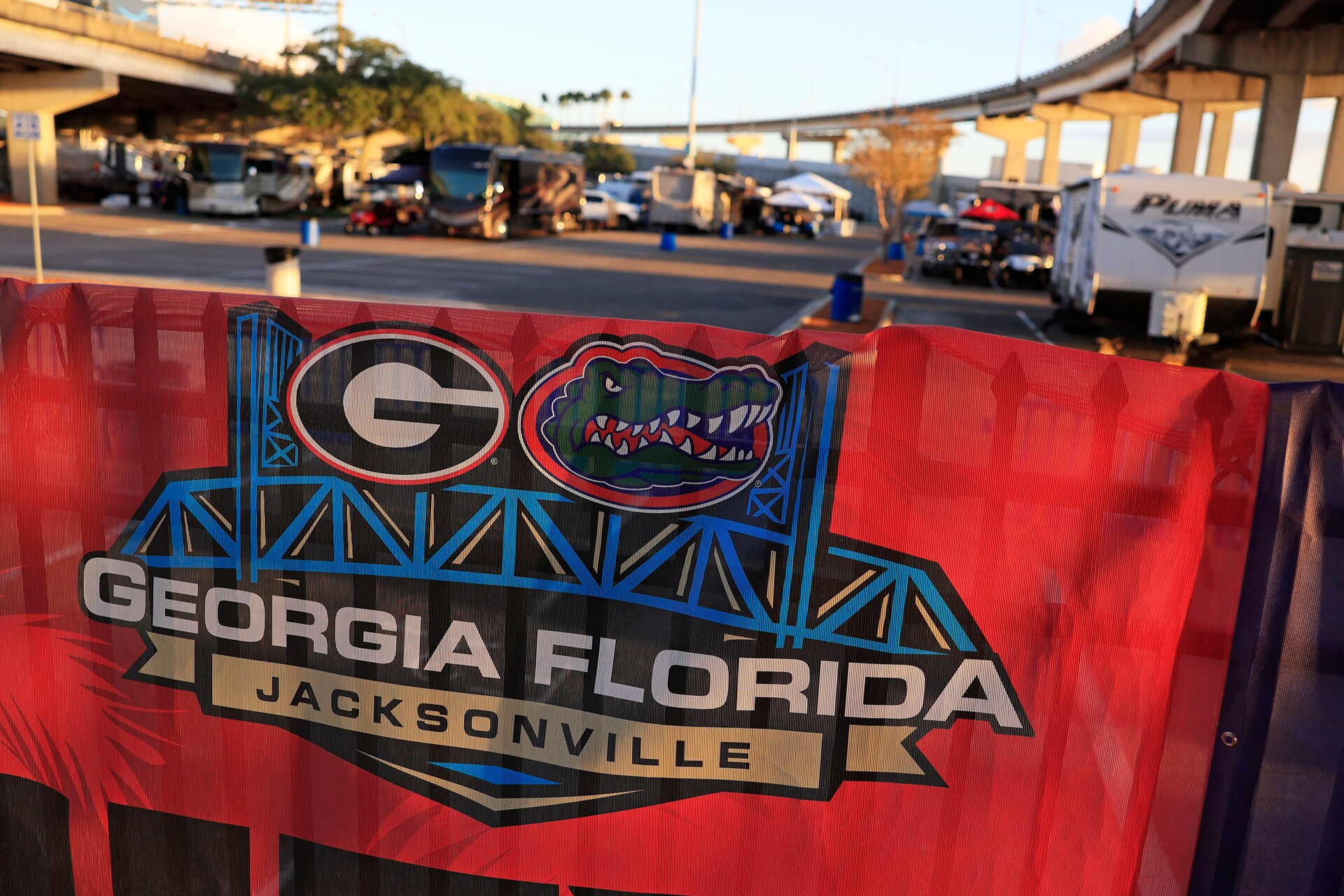 Signage hangs on a fence outside RV City Tuesday, Oct. 24, 2023 at parking lot E of EverBank Stadium in Jacksonville, Fla. Dozens of RVs and people came to tailgate for the days leading up to this Saturday, Oct. 28 for the annual Florida-Georgia college football game.