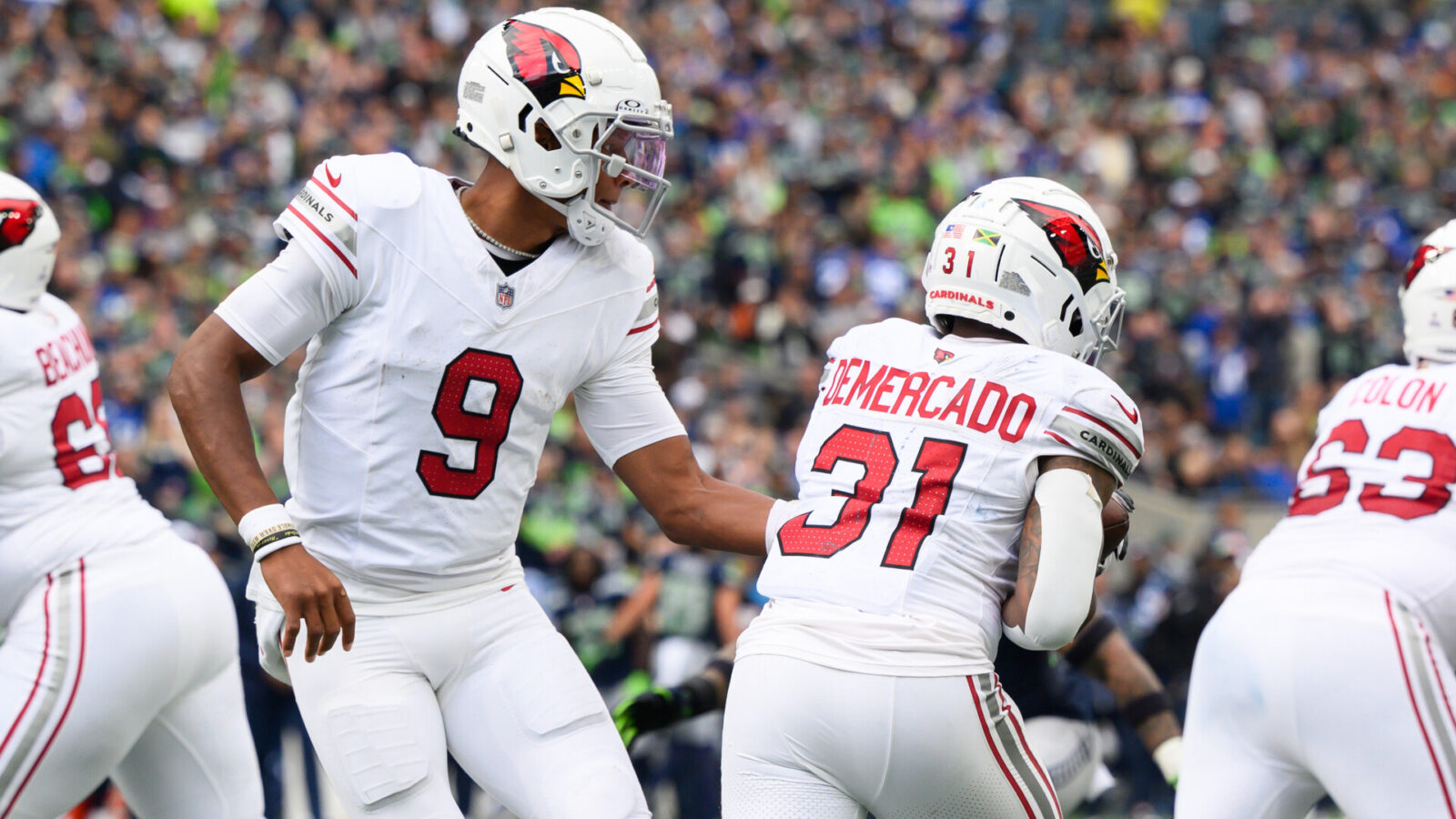 Oct 22, 2023; Seattle, Washington, USA; Arizona Cardinals quarterback Joshua Dobbs (9) hands the ball to Arizona Cardinals running back Emari Demercado (31) during the game at Lumen Field.
