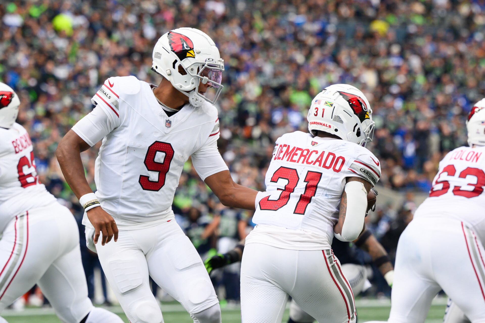 Oct 22, 2023; Seattle, Washington, USA; Arizona Cardinals quarterback Joshua Dobbs (9) hands the ball to Arizona Cardinals running back Emari Demercado (31) during the game at Lumen Field.