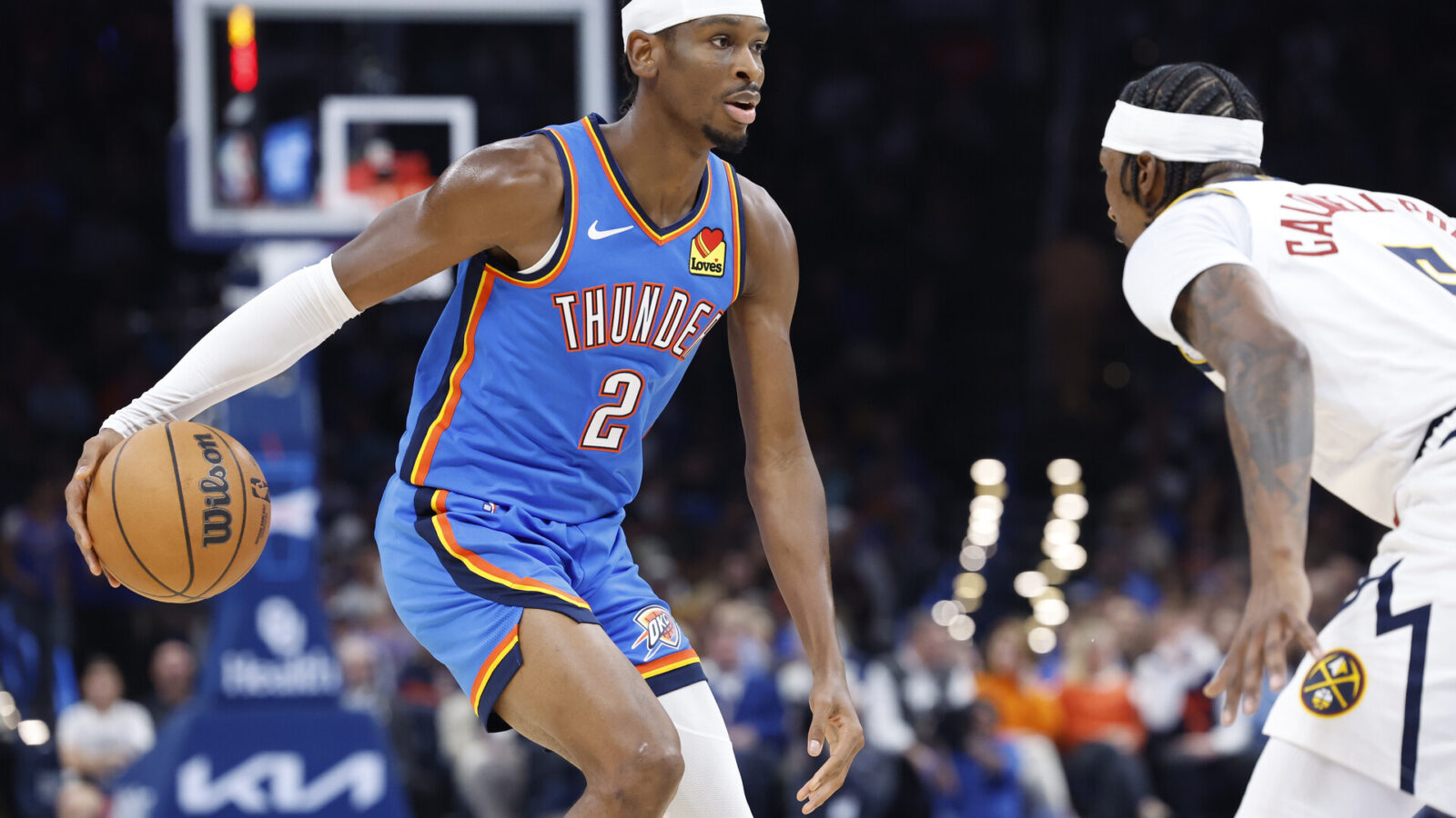 Oct 29, 2023; Oklahoma City, Oklahoma, USA; Oklahoma City Thunder guard Shai Gilgeous-Alexander (2) drives against Denver Nuggets guard Kentavious Caldwell-Pope (5) during the second half at Paycom Center.