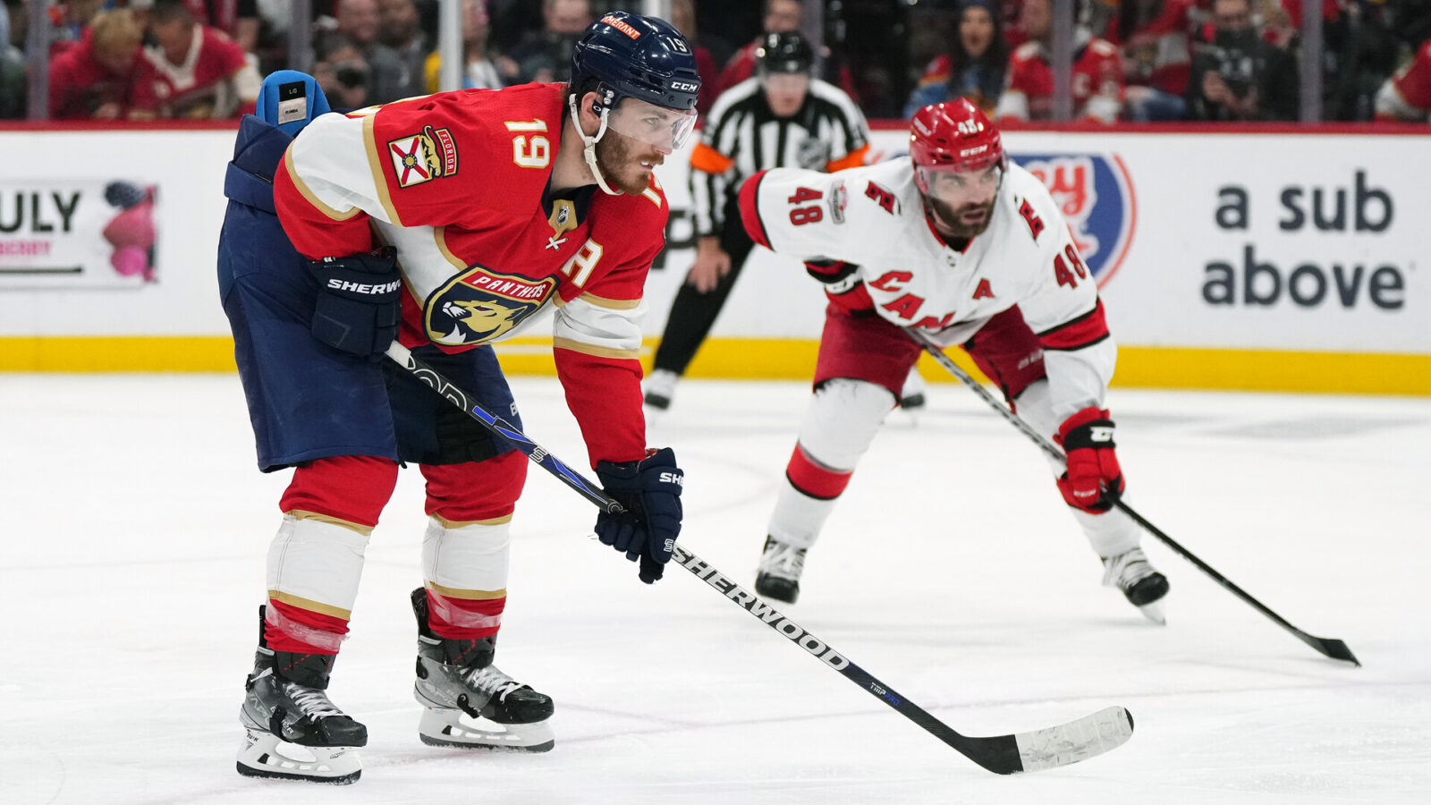 May 22, 2023; Sunrise, Florida, USA; Florida Panthers left wing Matthew Tkachuk (19) takes a position on the ice in front of Carolina Hurricanes left wing Jordan Martinook (48) during the second period in game three of the Eastern Conference Finals of the 2023 Stanley Cup Playoffs at FLA Live Arena.