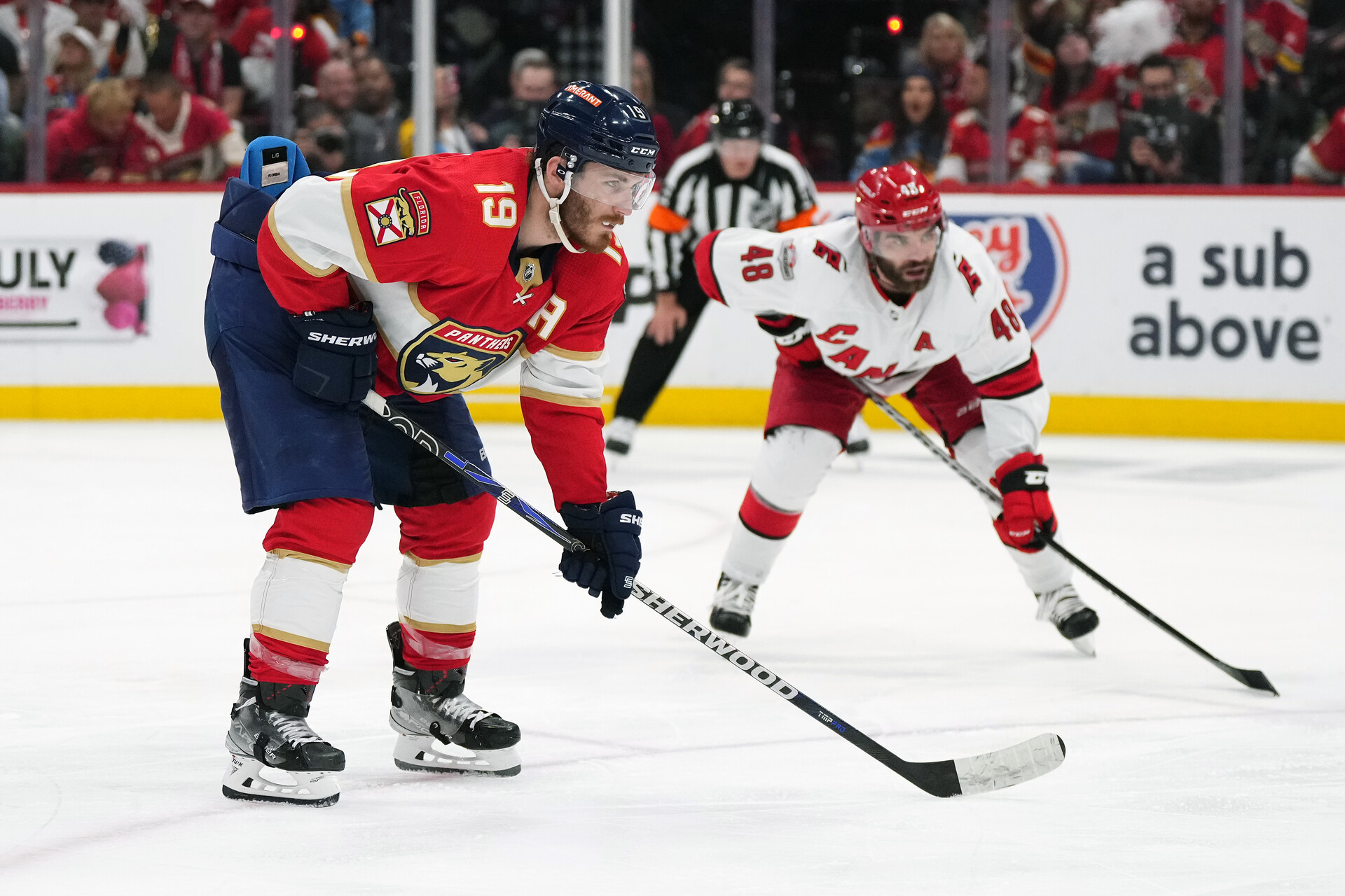 May 22, 2023; Sunrise, Florida, USA; Florida Panthers left wing Matthew Tkachuk (19) takes a position on the ice in front of Carolina Hurricanes left wing Jordan Martinook (48) during the second period in game three of the Eastern Conference Finals of the 2023 Stanley Cup Playoffs at FLA Live Arena.