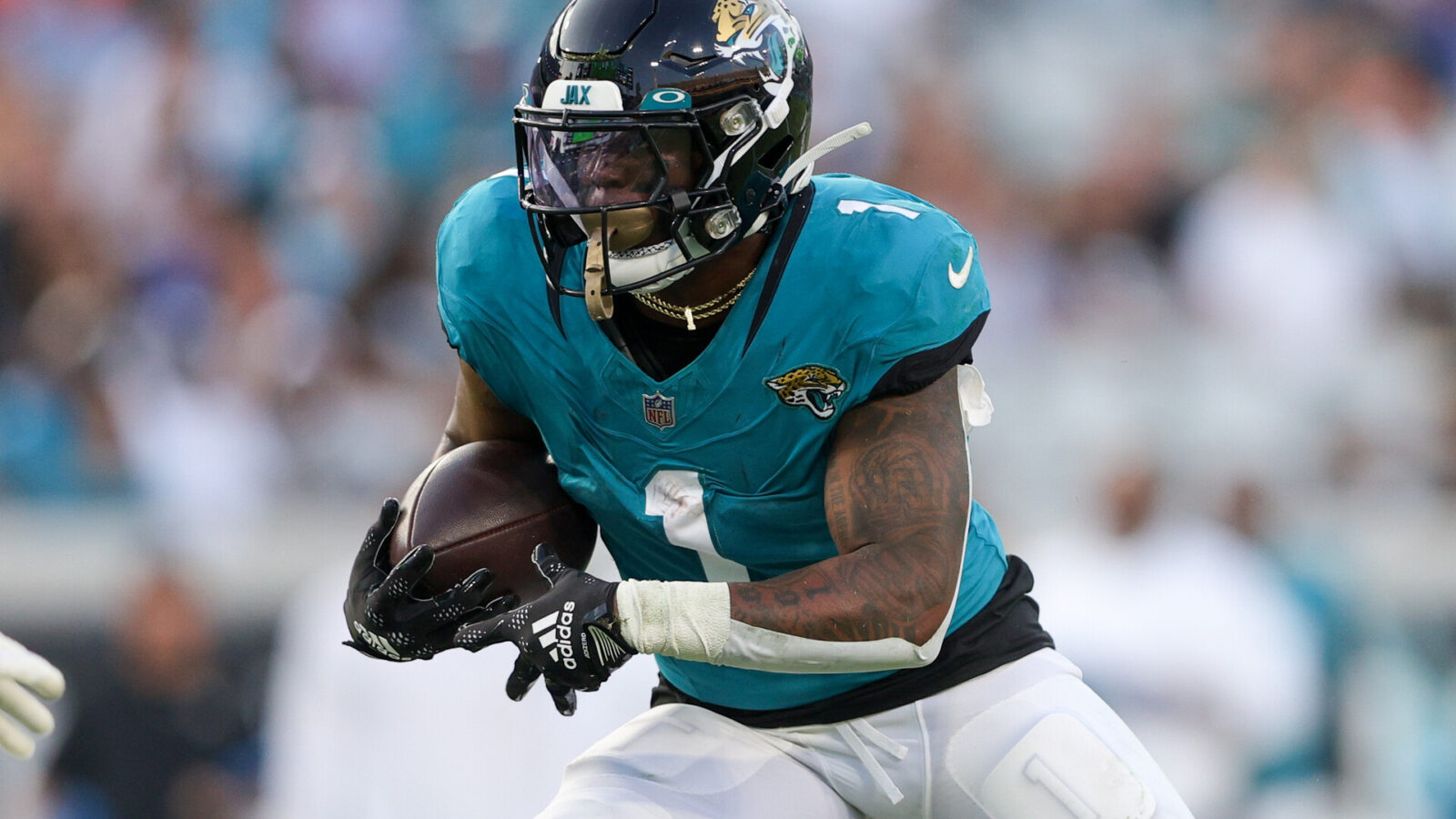 Aug 26, 2023; Jacksonville, Florida, USA; Jacksonville Jaguars running back Travis Etienne Jr. (1) runs with the ball against the Miami Dolphins in the first quarter at EverBank Stadium.