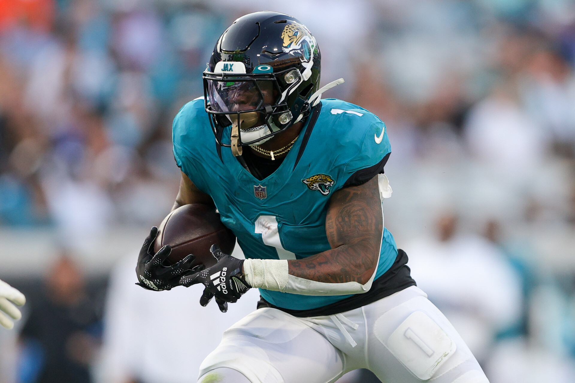 Aug 26, 2023; Jacksonville, Florida, USA; Jacksonville Jaguars running back Travis Etienne Jr. (1) runs with the ball against the Miami Dolphins in the first quarter at EverBank Stadium.