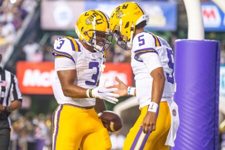 LSU Quarterback Jayden Daniels (5) celebrates with teammate Logan Diggs (3) after a touchdown against Grambling State.