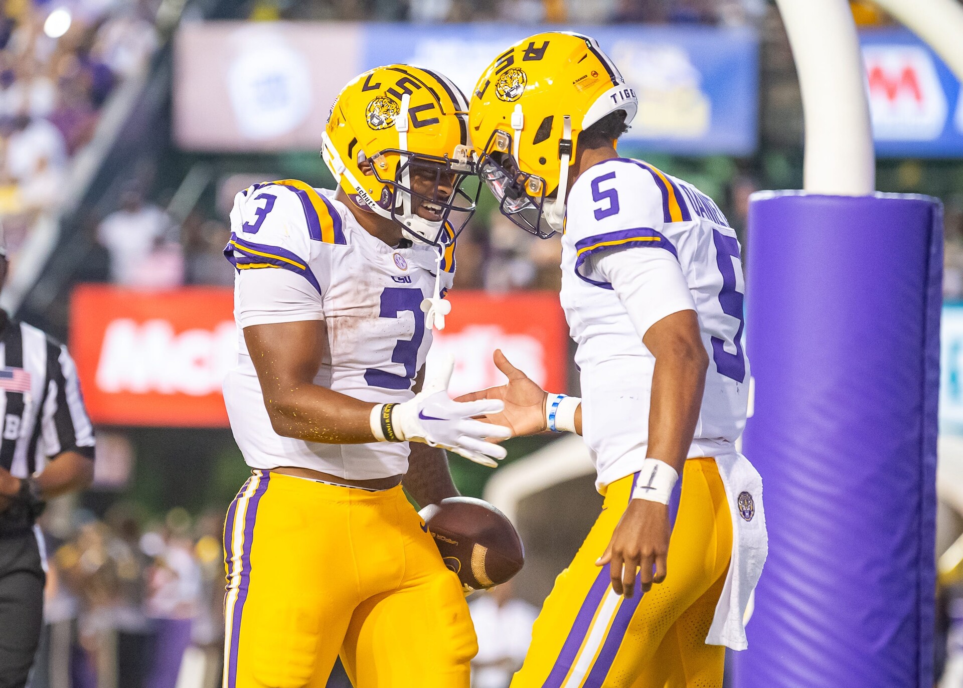 LSU Quarterback Jayden Daniels (5) celebrates with teammate Logan Diggs (3) after a touchdown against Grambling State.