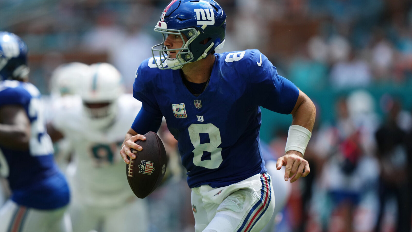 Oct 8, 2023; Miami Gardens, Florida, USA; New York Giants quarterback Daniel Jones (8) scrambles with the ball agianst the Miami Dolphins during the first half at Hard Rock Stadium.