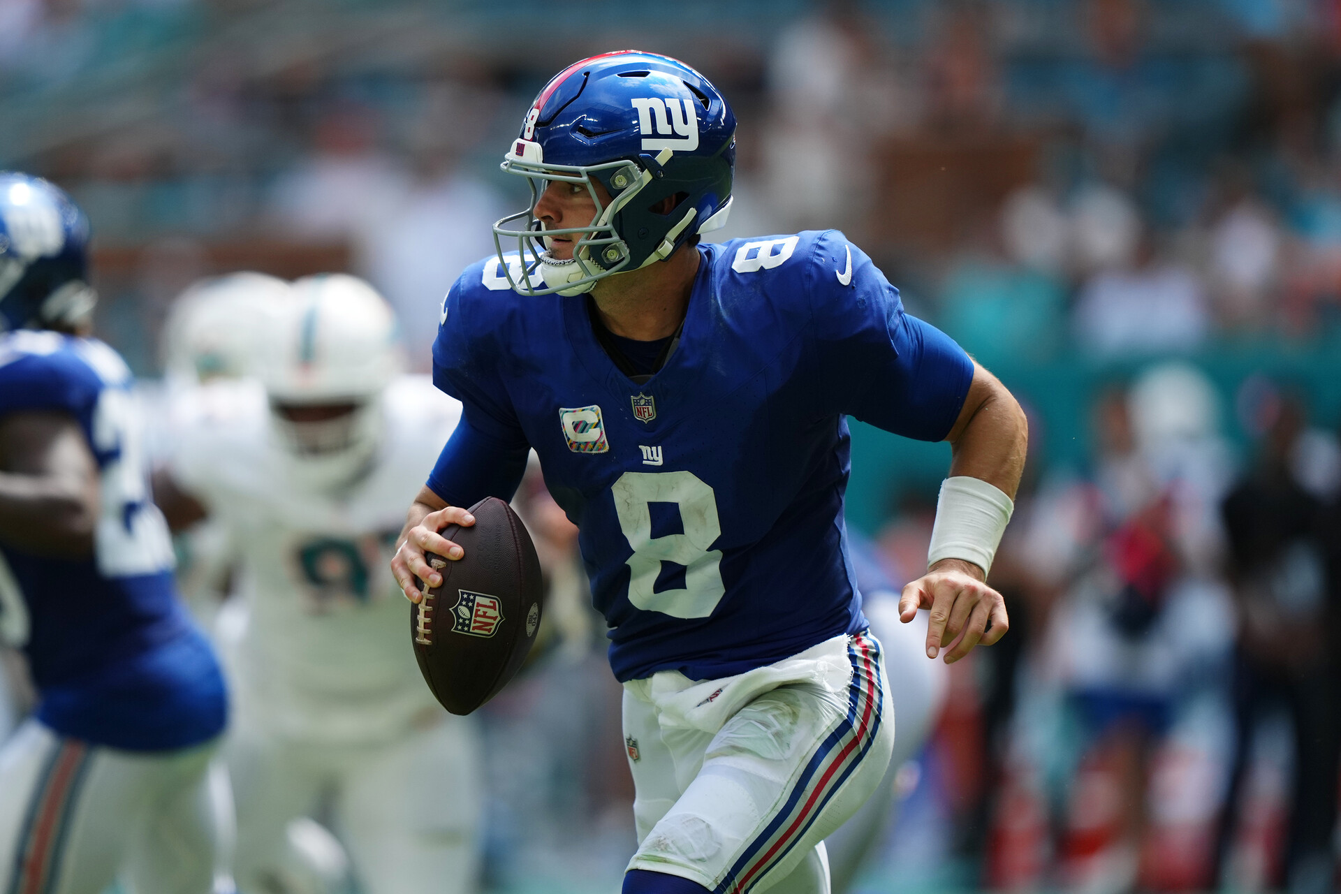 Oct 8, 2023; Miami Gardens, Florida, USA; New York Giants quarterback Daniel Jones (8) scrambles with the ball agianst the Miami Dolphins during the first half at Hard Rock Stadium.