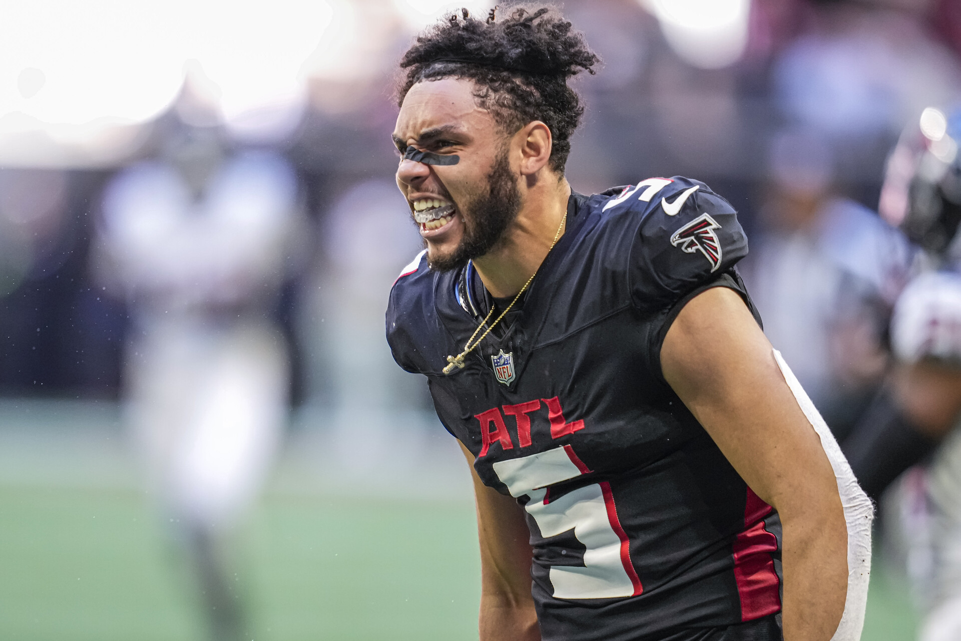 Atlanta Falcons wide receiver Drake London (5) reacts after making a catch and losing his helmet against the Houston Texans during the second half at Mercedes-Benz Stadium.