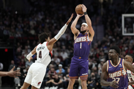 Oct 12, 2023; Portland, Oregon, USA; Phoenix Suns shooting guard Devin Booker (1) shoots the ball over Portland Trail Blazers shooting guard Matisse Thybulle (4) during the first half at Moda Center.