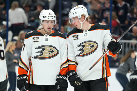 Oct 24, 2023; Columbus, Ohio, USA; Anaheim Ducks right wing Frank Vatrano (77) and defenseman Jackson LaCombe (60) talk during the second period against the Columbus Blue Jackets at Nationwide Arena.