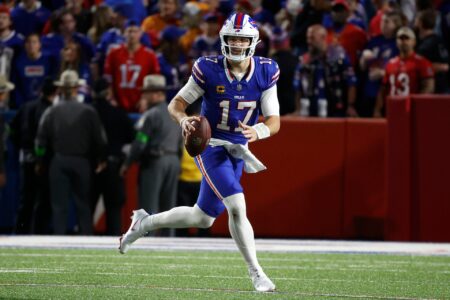Buffalo Bills quarterback Josh Allen (17) rolls to his left as he looks downfield.