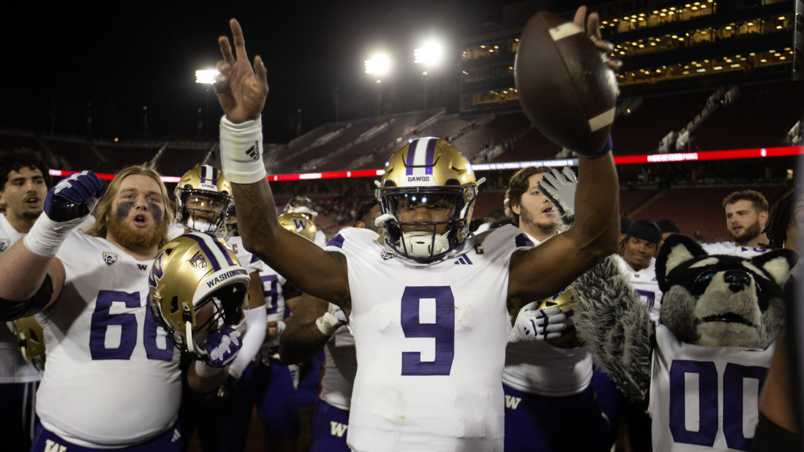 Oct 28, 2023; Stanford, California, USA; Washington Huskies quarterback Michael Penix Jr. (9) and his teammates celebrate their victory over the Stanford Cardinal at Stanford Stadium.
