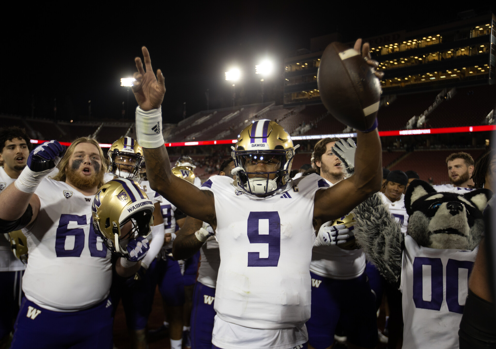 Oct 28, 2023; Stanford, California, USA; Washington Huskies quarterback Michael Penix Jr. (9) and his teammates celebrate their victory over the Stanford Cardinal at Stanford Stadium.