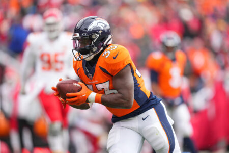 Denver Broncos running back Javonte Williams (33) carries the ball for a touchdown against the Kansas City Chiefs in the first quarter at Empower Field at Mile High.