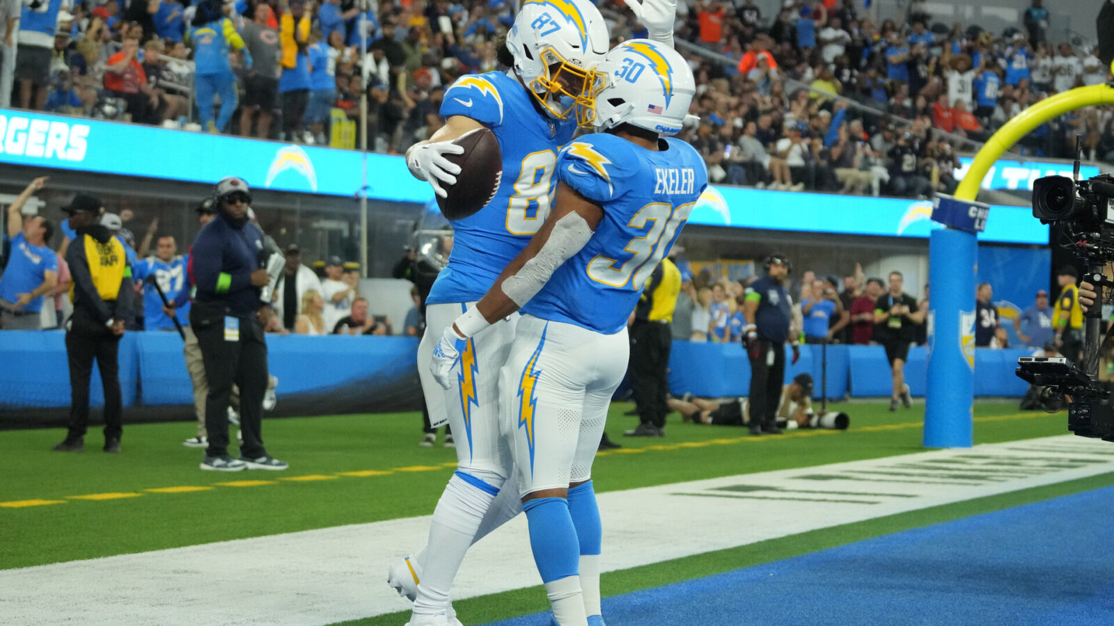 Oct 29, 2023; Inglewood, California, USA; Los Angeles Chargers wide receiver Simi Fehoko (87) celebrates with running back Austin Ekeler (30) after scoring on a 9-yard touchdown reception against the Chicago Bears in the first half at SoFi Stadium.