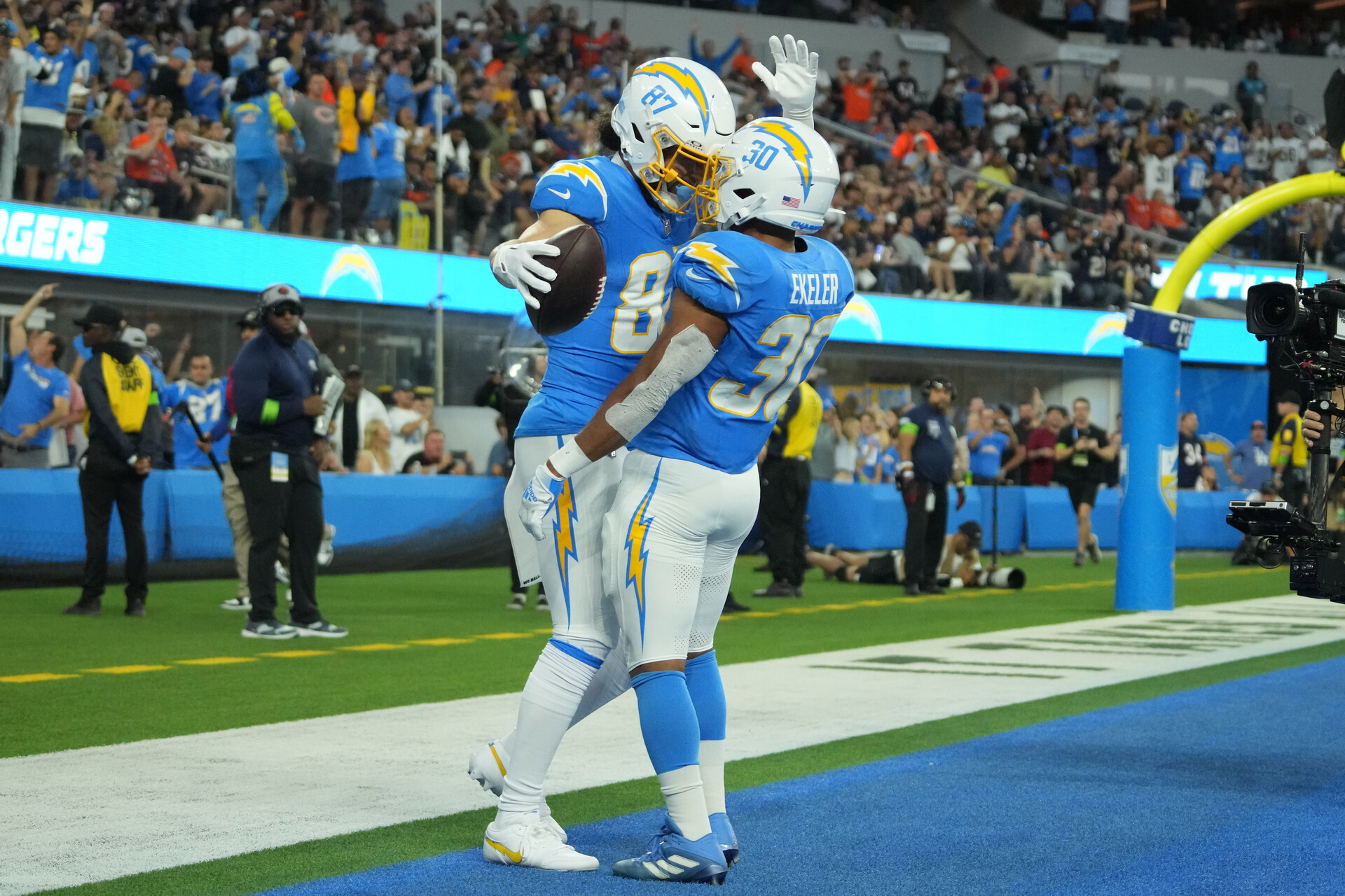 Oct 29, 2023; Inglewood, California, USA; Los Angeles Chargers wide receiver Simi Fehoko (87) celebrates with running back Austin Ekeler (30) after scoring on a 9-yard touchdown reception against the Chicago Bears in the first half at SoFi Stadium.