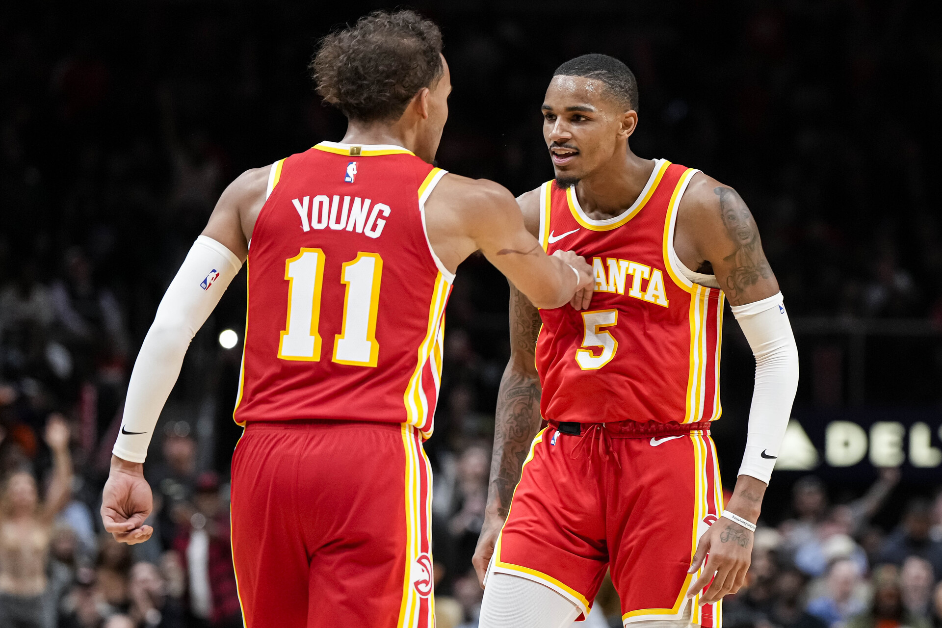 Oct 30, 2023; Atlanta, Georgia, USA; Atlanta Hawks guards Trae Young (11) and Dejounte Murray (5) react after a basket against the Minnesota Timberwolves during the second half at State Farm Arena.