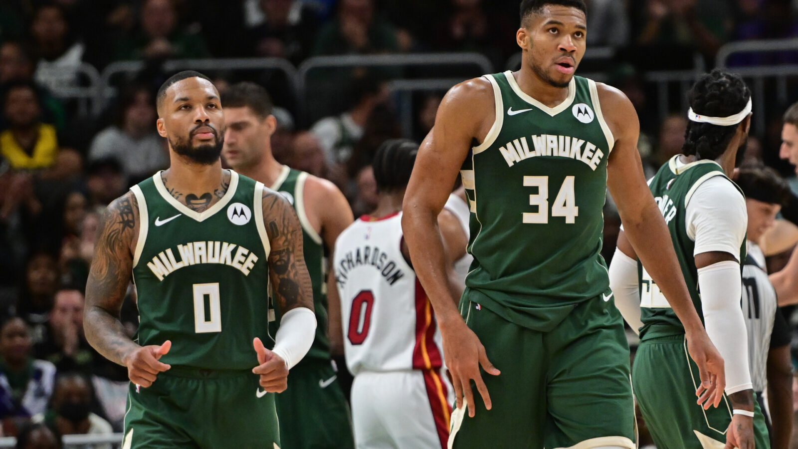 Oct 30, 2023; Milwaukee, Wisconsin, USA; Milwaukee Bucks forward Giannis Antetokounmpo (34) and guard Damian Lillard (0) looks on during a timeout in the fourth quarter against the Miami Heat at Fiserv Forum.