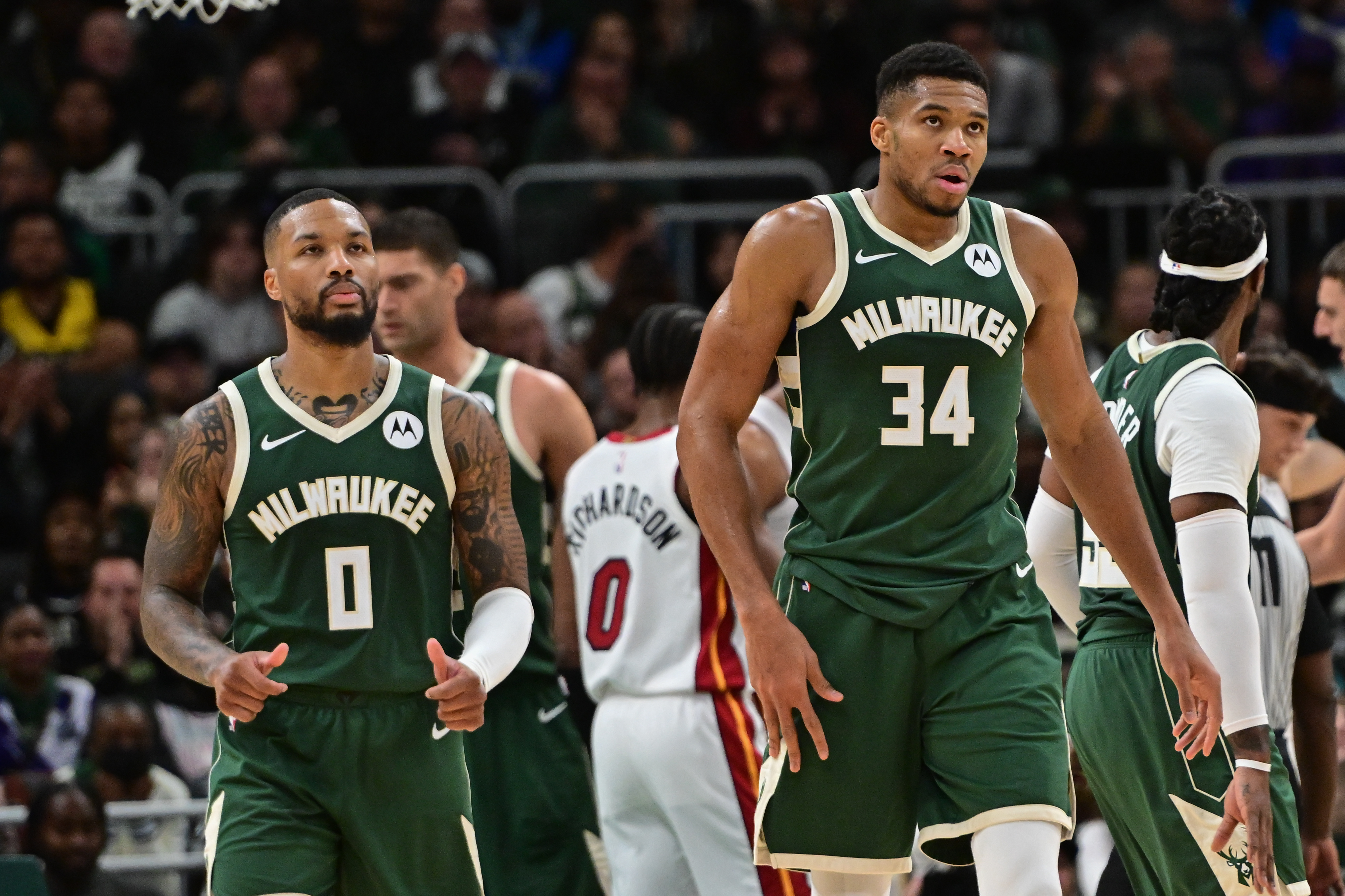Oct 30, 2023; Milwaukee, Wisconsin, USA; Milwaukee Bucks forward Giannis Antetokounmpo (34) and guard Damian Lillard (0) looks on during a timeout in the fourth quarter against the Miami Heat at Fiserv Forum.