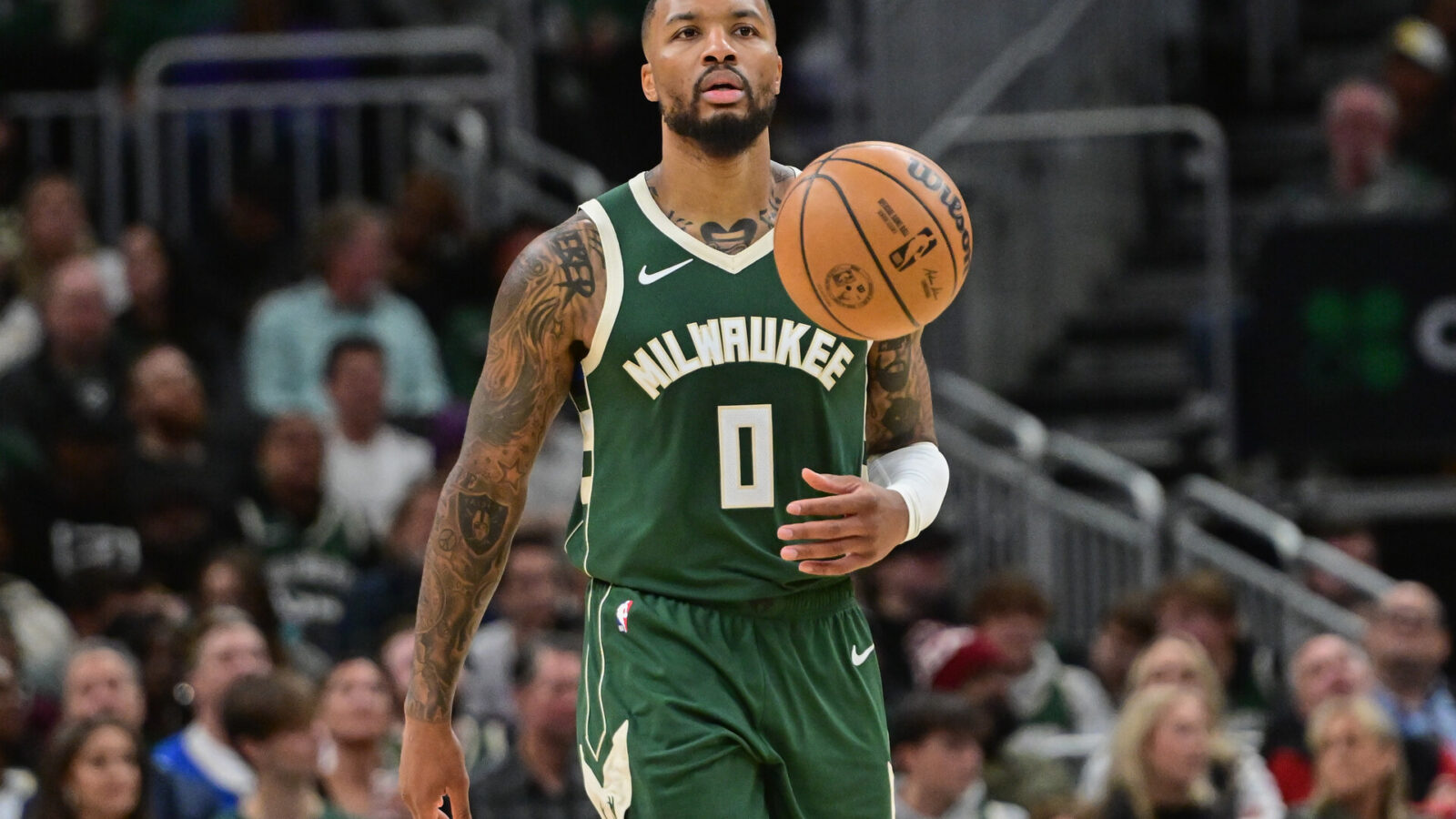 Milwaukee Bucks guard Damian Lillard (0) brings the ball down court in the second quarter against the Miami Heat at Fiserv Forum.