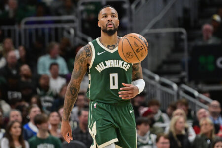 Milwaukee Bucks guard Damian Lillard (0) brings the ball down court in the second quarter against the Miami Heat at Fiserv Forum.