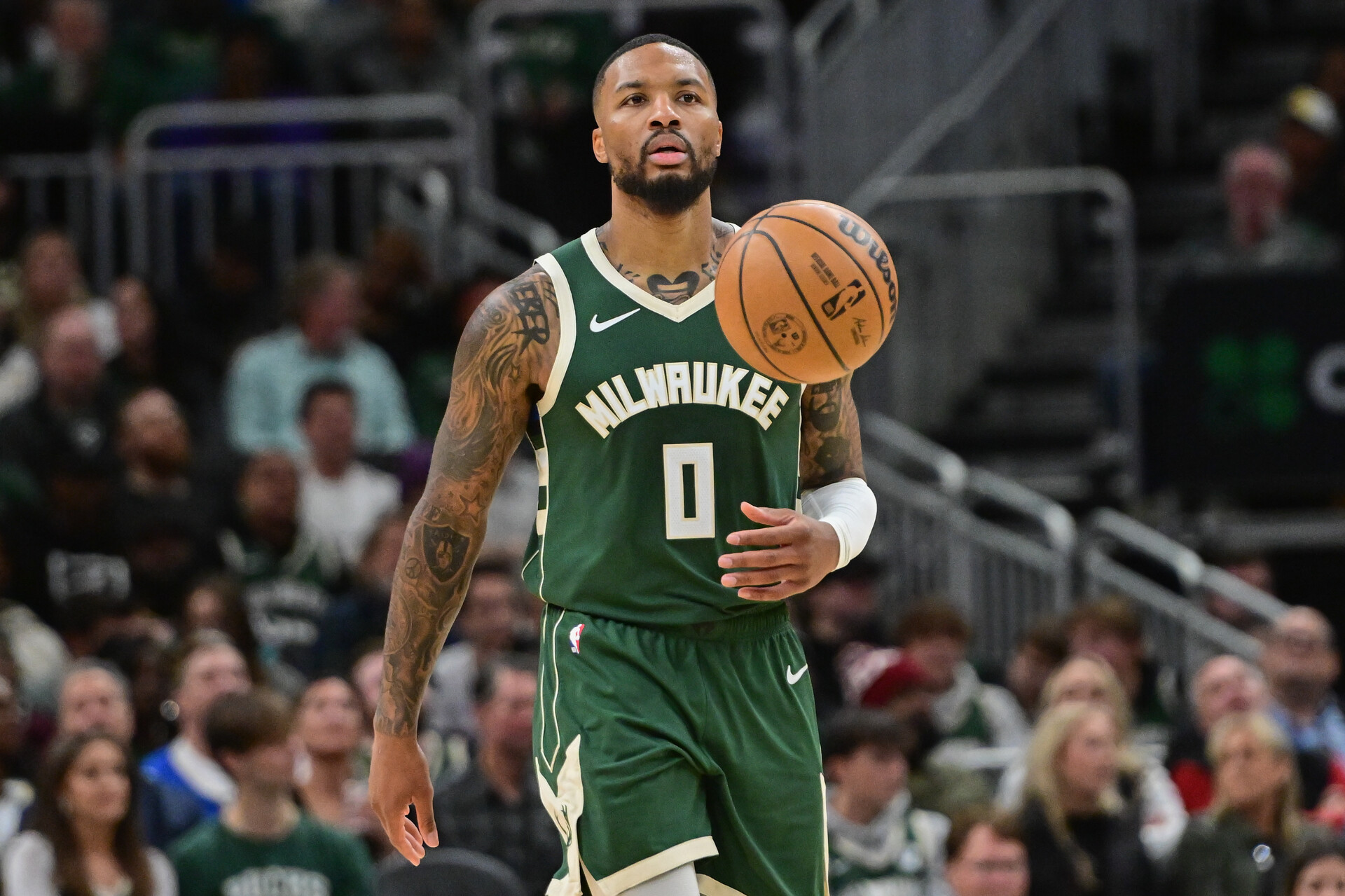 Milwaukee Bucks guard Damian Lillard (0) brings the ball down court in the second quarter against the Miami Heat at Fiserv Forum.