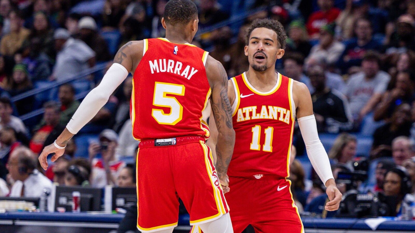 Atlanta Hawks guard Trae Young (11) slaps hands with guard Dejounte Murray (5) after he makes a basket against the New Orleans Pelicans during the second half at Smoothie King Center.