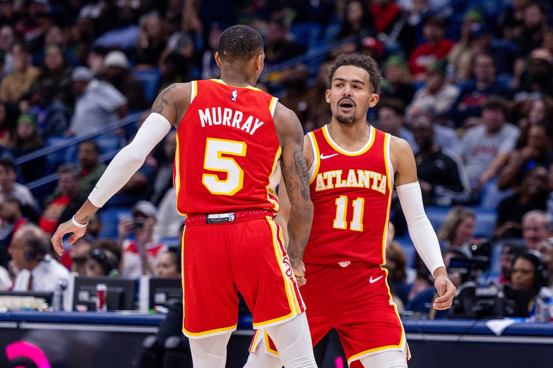 Atlanta Hawks guard Trae Young (11) slaps hands with guard Dejounte Murray (5) after he makes a basket against the New Orleans Pelicans during the second half at Smoothie King Center.