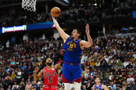 Nov 4, 2023; Denver, Colorado, USA; Denver Nuggets center Nikola Jokic (15) grabs a rebound over Chicago Bulls guard Jevon Carter (5) in the second half at Ball Arena.