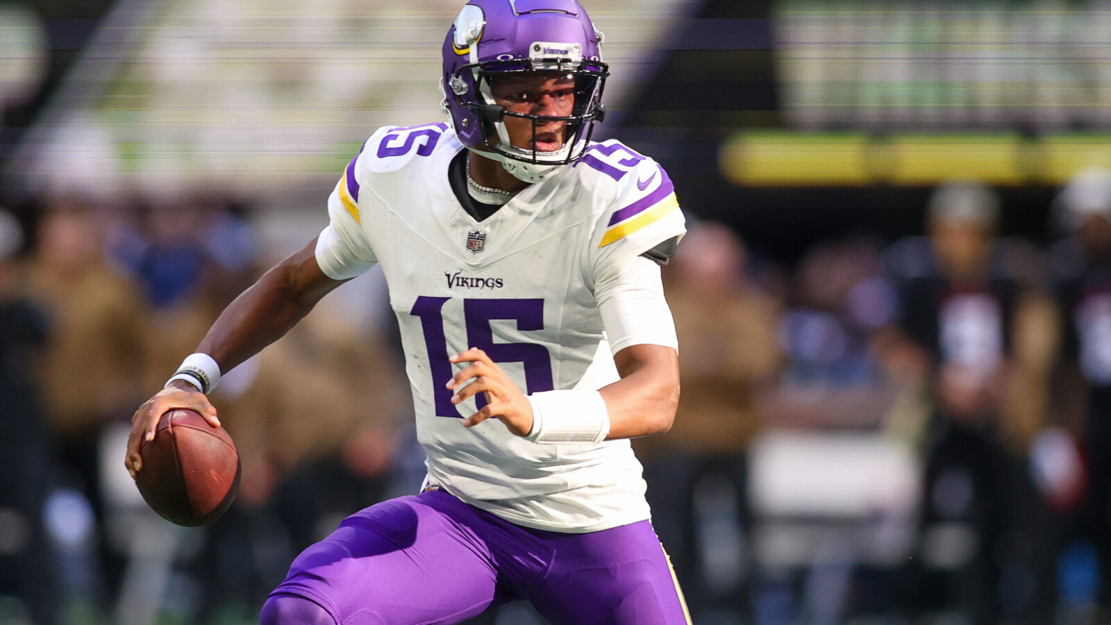Minnesota Vikings quarterback Joshua Dobbs (15) scrambles against the Atlanta Falcons in the second half at Mercedes-Benz Stadium.